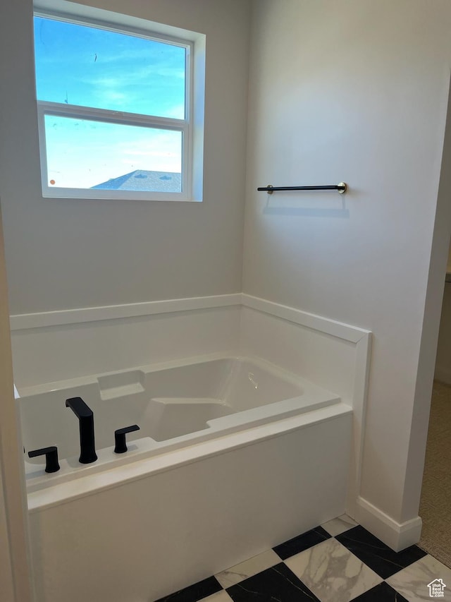 full bath with baseboards and a bath
