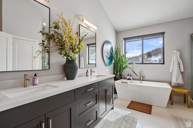 8680 Saddleback Cir, Park City, UT 84098 - bathroom featuring lofted ceiling, a soaking tub, double vanity, and tile patterned flooring