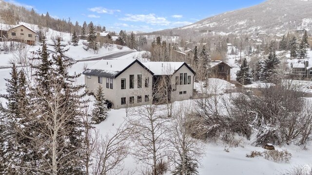 snowy aerial view with a mountain view