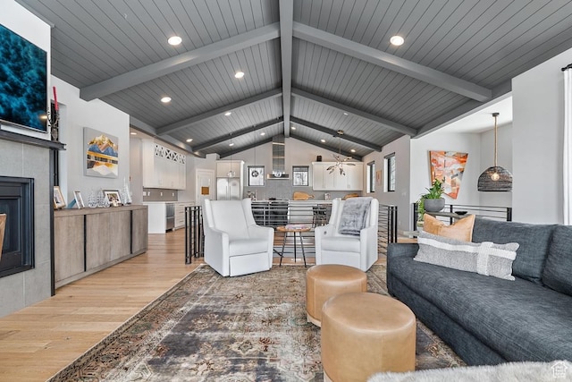 8680 Saddleback Cir, Park City, UT 84098 - living area with light wood-style flooring, a tiled fireplace, recessed lighting, and ceiling fan