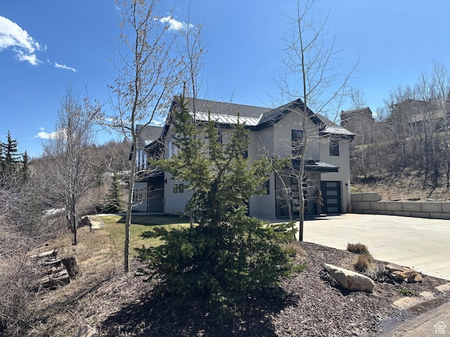 8680 Saddleback Cir, Park City, UT 84098 - view of side of property with driveway, stucco siding, and a garage