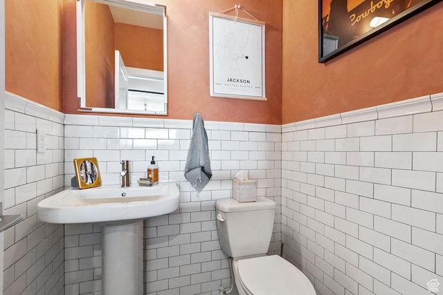 8680 Saddleback Cir, Park City, UT 84098 - half bath featuring toilet, tile walls, and a wainscoted wall