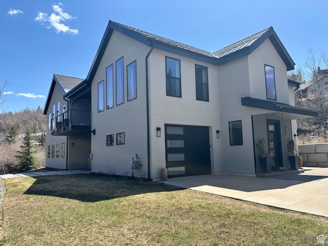 8680 Saddleback Cir, Park City, UT 84098 - back of house with an attached garage, a yard, stucco siding, driveway, and a patio area