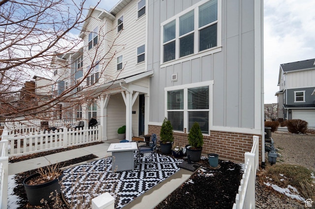 exterior space featuring brick siding and board and batten siding