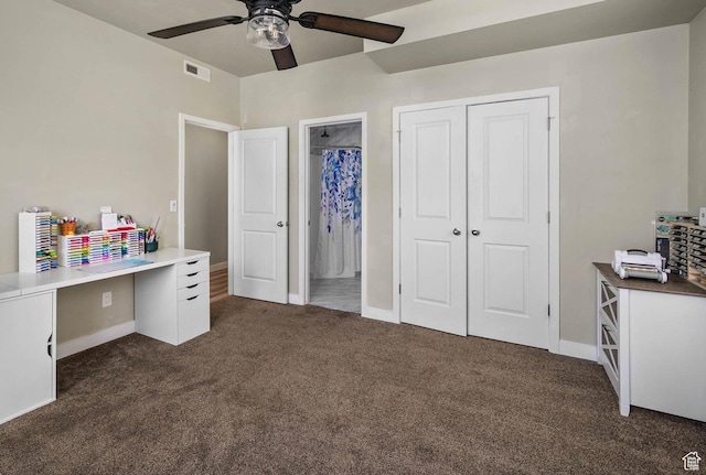 interior space featuring a closet, a ceiling fan, dark colored carpet, baseboards, and visible vents
