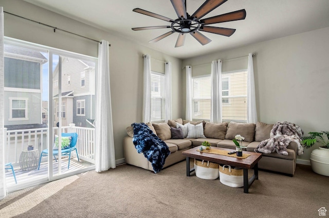 living room with ceiling fan and light colored carpet