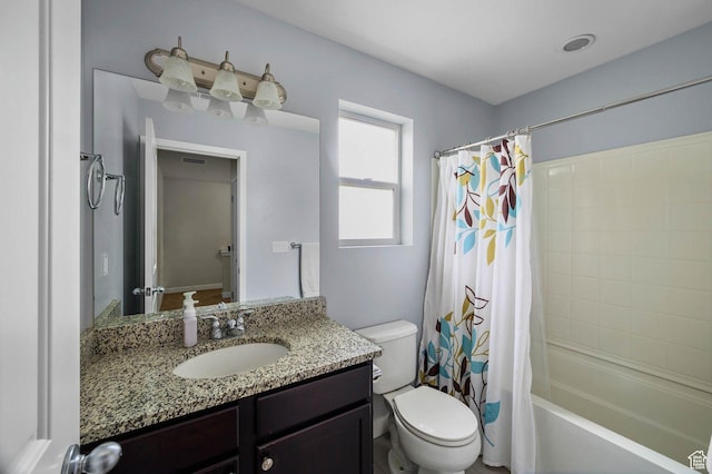 bathroom with toilet, vanity, and shower / bath combo