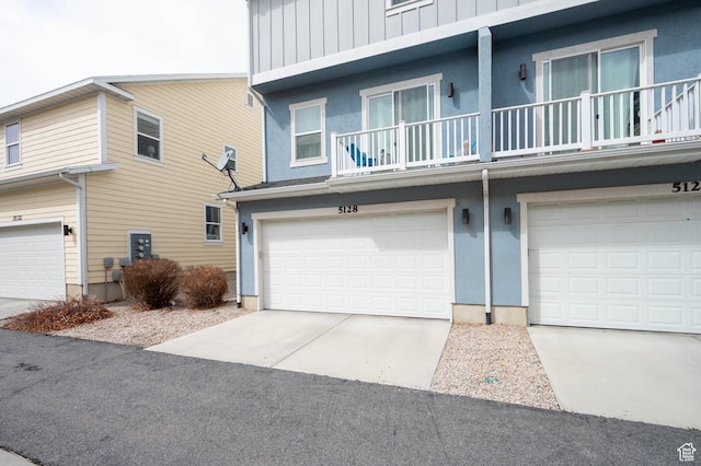 exterior space featuring board and batten siding, concrete driveway, and a garage