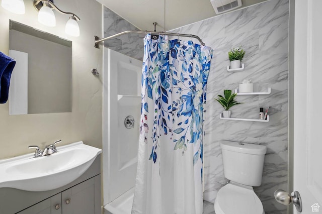 bathroom with toilet, vanity, a shower stall, and visible vents