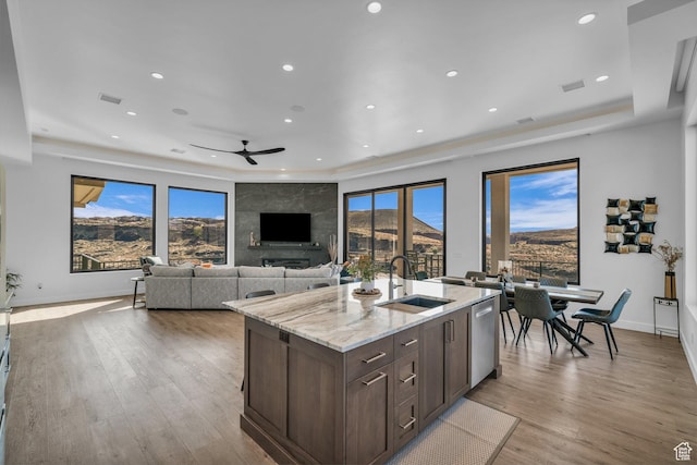 599 W 170 S, La Verkin, UT 84745 - kitchen with dark brown cabinetry, a sink, light stone countertops, light wood-type flooring, and ceiling fan