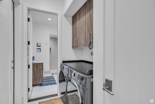 599 W 170 S, La Verkin, UT 84745 - clothes washing area featuring washing machine and dryer, tile patterned flooring, and cabinet space