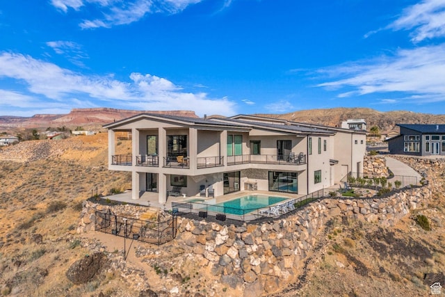 599 W 170 S, La Verkin, UT 84745 - back of property featuring a balcony, fence, stucco siding, a mountain view, and a patio area