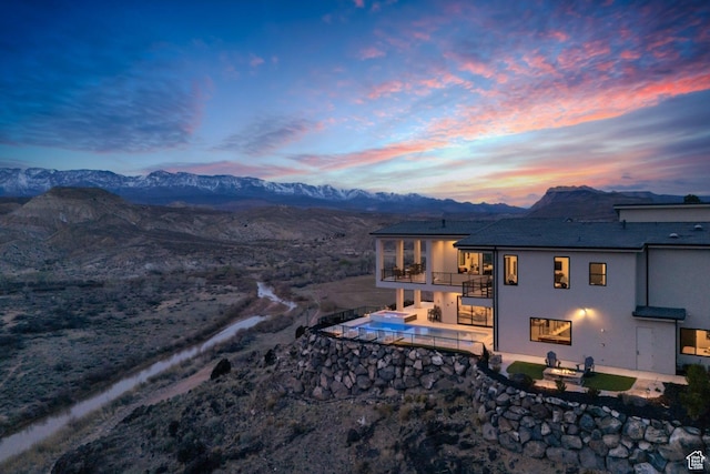 599 W 170 S, La Verkin, UT 84745 - back of property with a balcony, an outdoor pool, stucco siding, a mountain view, and a patio area