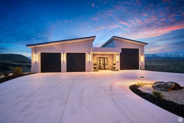 599 W 170 S, La Verkin, UT 84745 - contemporary home featuring stone siding, fence, an attached garage, concrete driveway, and stucco siding