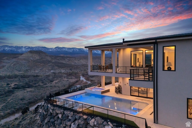 599 W 170 S, La Verkin, UT 84745 - pool at dusk with a patio, a mountain view, fence, and a pool with connected hot tub