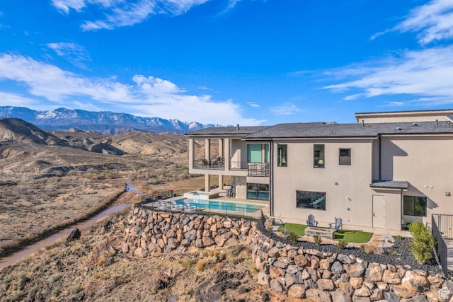599 W 170 S, La Verkin, UT 84745 - back of property featuring stucco siding, a balcony, solar panels, a patio, and an outdoor pool