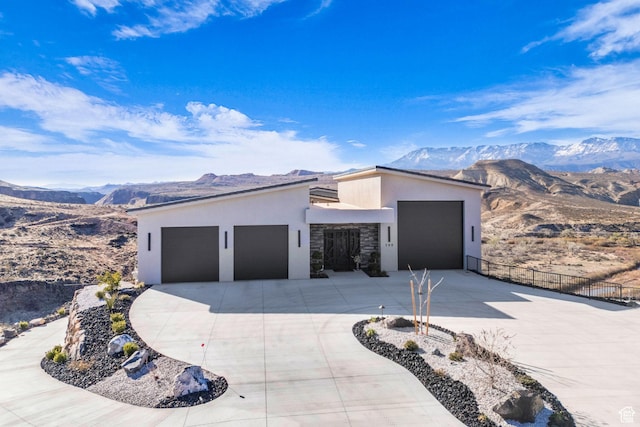 599 W 170 S, La Verkin, UT 84745 - view of front facade featuring concrete driveway, stucco siding, fence, a mountain view, and a garage