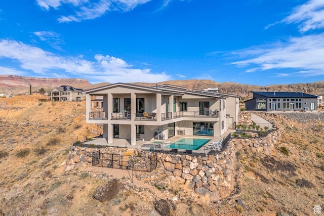 599 W 170 S, La Verkin, UT 84745 - back of house featuring stucco siding, a balcony, a patio, an outdoor pool, and a mountain view