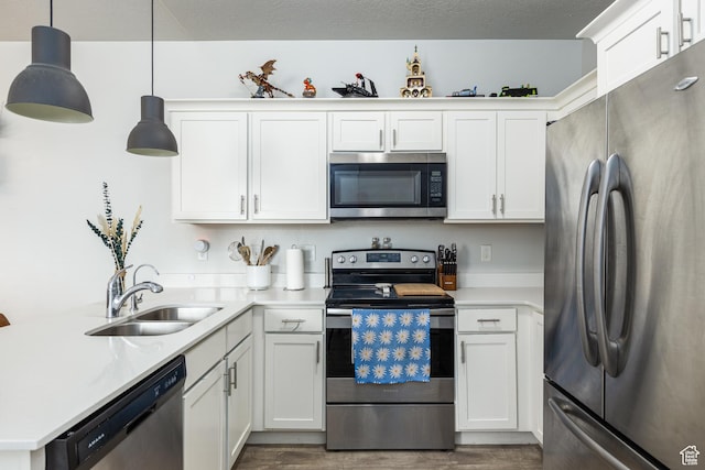 14472 S Selvig Way Unit 303, Herriman, UT 84096 - kitchen with light countertops, dark wood-style flooring, stainless steel appliances, a sink, and a peninsula