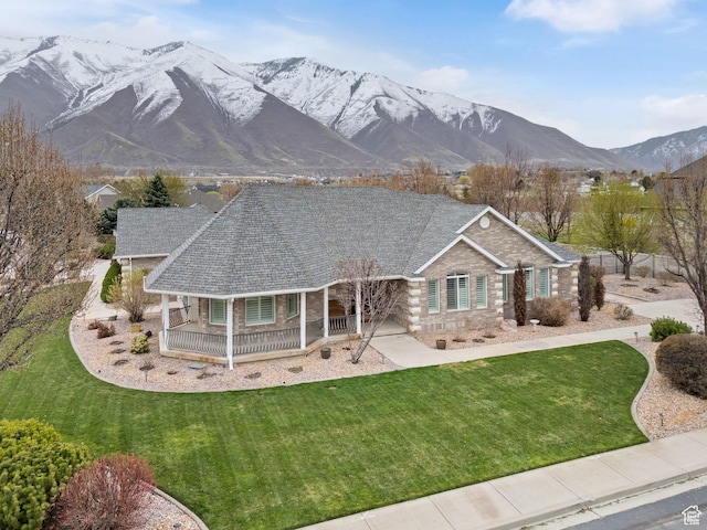 1325 W Park Meadows Dr, Mapleton, UT 84664 - view of front facade with a porch, stone siding, a front yard, and a mountain view