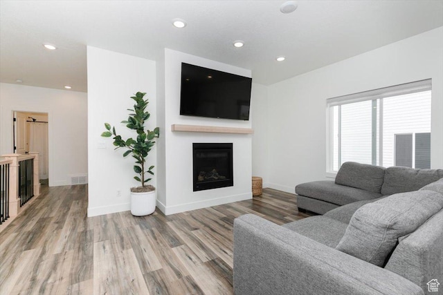 602 W 20 N, Hyrum, UT 84319 - living area featuring visible vents, baseboards, a fireplace, recessed lighting, and light wood-style floors