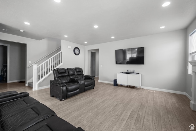 13099 S Twisted Oak Dr, Herriman, UT 84096 - living room with baseboards, recessed lighting, light wood-style floors, and stairway