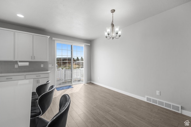 13099 S Twisted Oak Dr, Herriman, UT 84096 - dining space with an inviting chandelier, baseboards, light wood finished floors, and visible vents