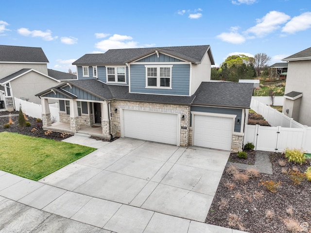 13099 S Twisted Oak Dr, Herriman, UT 84096 - view of front of house with fence, a gate, stone siding, and board and batten siding