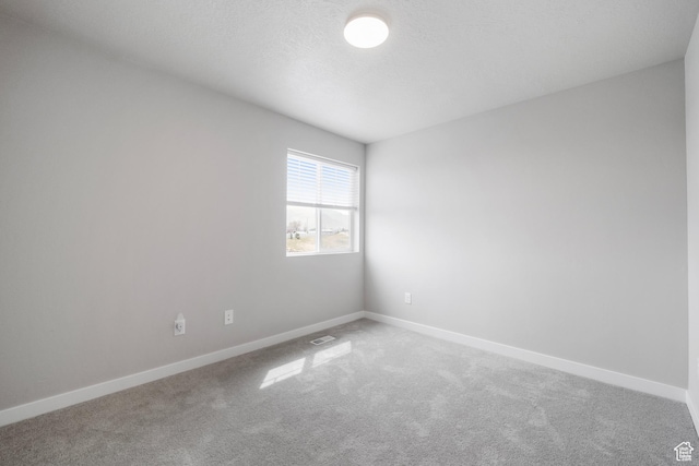 13099 S Twisted Oak Dr, Herriman, UT 84096 - unfurnished room with baseboards, carpet floors, a textured ceiling, and visible vents