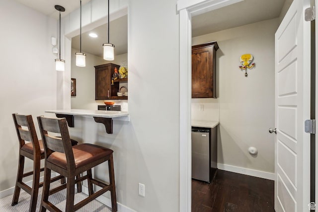 5265 N Laurelwood St N, Heber City, UT 84032 - bar with pendant lighting, dark wood finished floors, indoor wet bar, stainless steel refrigerator, and baseboards