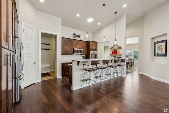 5265 N Laurelwood St N, Heber City, UT 84032 - kitchen with dark wood-style flooring, baseboards, appliances with stainless steel finishes, and a breakfast bar