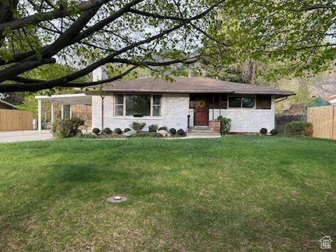 2084 Robins Ave, Ogden, UT 84401 - ranch-style house with an attached carport and brick siding