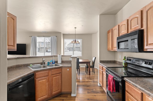 6613 W Ivy Gable Dr, West Jordan, UT 84081 - kitchen with black appliances, a sink, dark wood-style flooring, dark countertops, and a chandelier