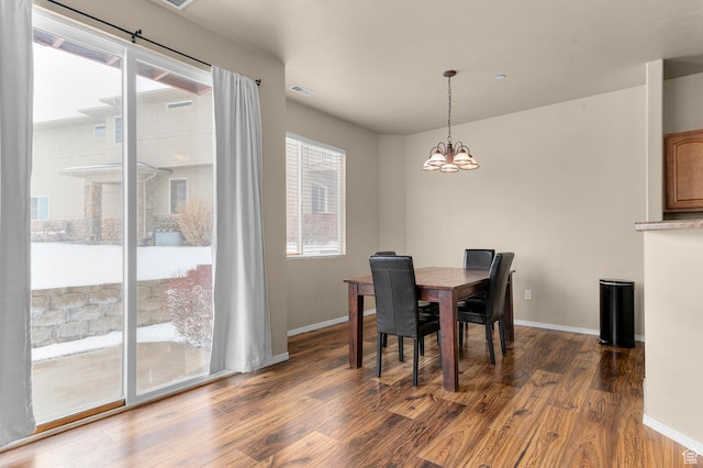 6613 W Ivy Gable Dr, West Jordan, UT 84081 - dining area with wood finished floors, a chandelier, and baseboards