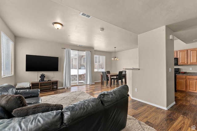 6613 W Ivy Gable Dr, West Jordan, UT 84081 - living room with a chandelier, dark wood finished floors, and baseboards