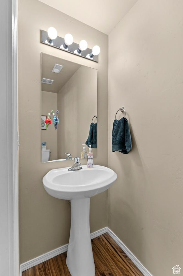 6613 W Ivy Gable Dr, West Jordan, UT 84081 - bathroom featuring wood finished floors, baseboards, and a sink