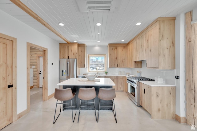 2032 Timber Lakes Dr Unit 950, Heber City, UT 84032 - kitchen with light brown cabinets, a breakfast bar, recessed lighting, and appliances with stainless steel finishes