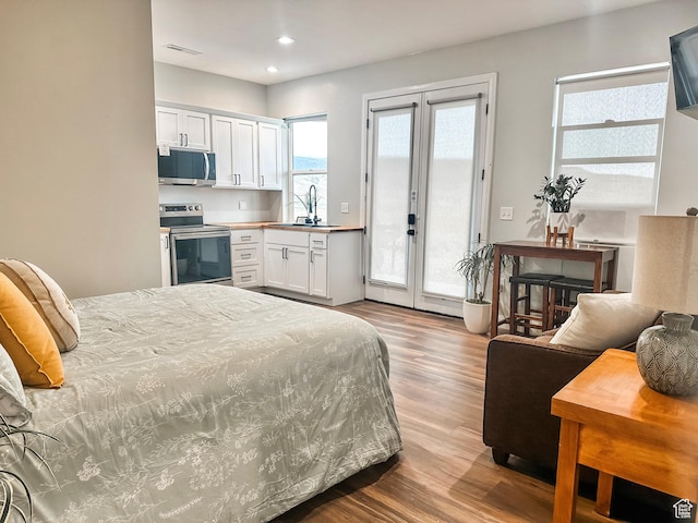 690 N Main St, Antimony, UT 84712 - bedroom with french doors, a sink, wood finished floors, access to outside, and recessed lighting