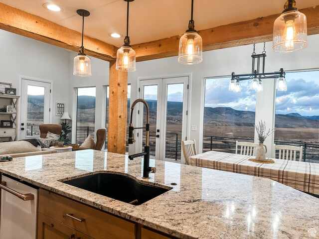 690 N Main St, Antimony, UT 84712 - kitchen featuring a mountain view, open floor plan, beamed ceiling, and a sink