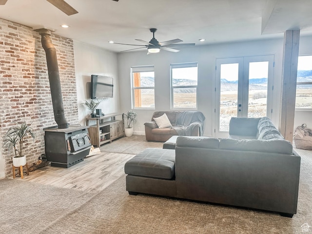 690 N Main St, Antimony, UT 84712 - living area with recessed lighting, a ceiling fan, brick wall, a wood stove, and french doors