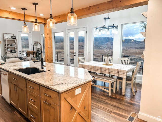690 N Main St, Antimony, UT 84712 - kitchen with dark wood-style floors, beam ceiling, a sink, and baseboards