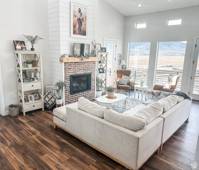 690 N Main St, Antimony, UT 84712 - living room with dark wood-style flooring, a high ceiling, recessed lighting, and a brick fireplace