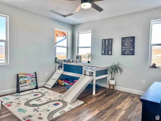 690 N Main St, Antimony, UT 84712 - bedroom with baseboards, dark wood-style flooring, a ceiling fan, and attic access