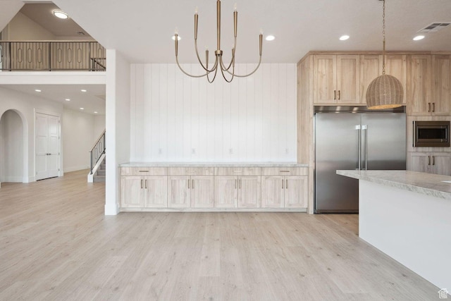3087 E 2220 S, St George, UT 84790 - kitchen featuring built in appliances, light wood-style floors, light brown cabinetry, a chandelier, and light stone counters