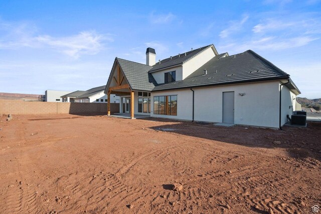 3087 E 2220 S, St George, UT 84790 - back of property featuring cooling unit, a chimney, a patio, a tile roof, and stucco siding