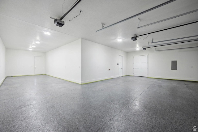 3087 E 2220 S, St George, UT 84790 - garage featuring electric panel, a garage door opener, and baseboards