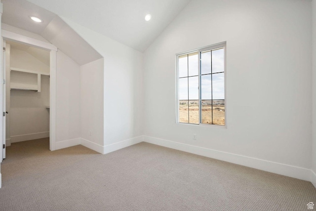 3087 E 2220 S, St George, UT 84790 - unfurnished bedroom featuring light colored carpet, lofted ceiling, baseboards, recessed lighting, and a walk in closet