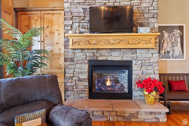 interior details with a fireplace and wood finished floors