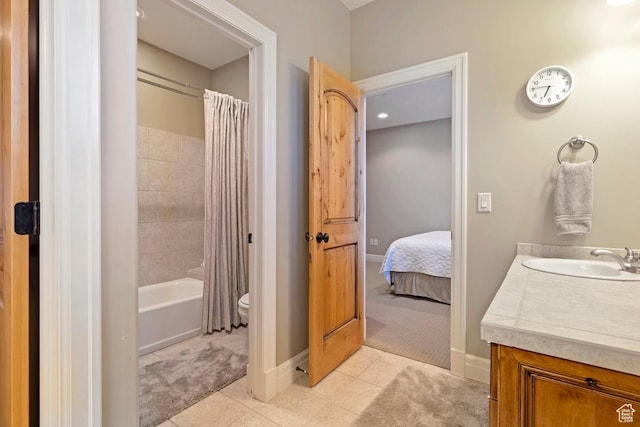 ensuite bathroom featuring vanity, shower / bathtub combination with curtain, toilet, baseboards, and tile patterned floors