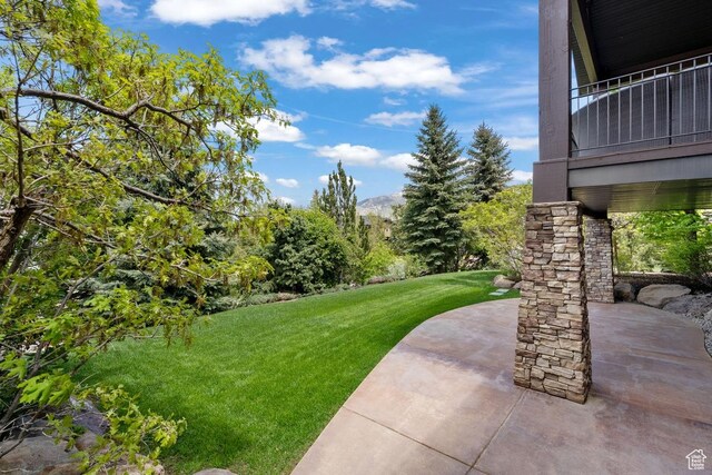 1562 E Granite Brook Ct S, Draper, UT 84020 - view of green lawn with a patio area and a mountain view